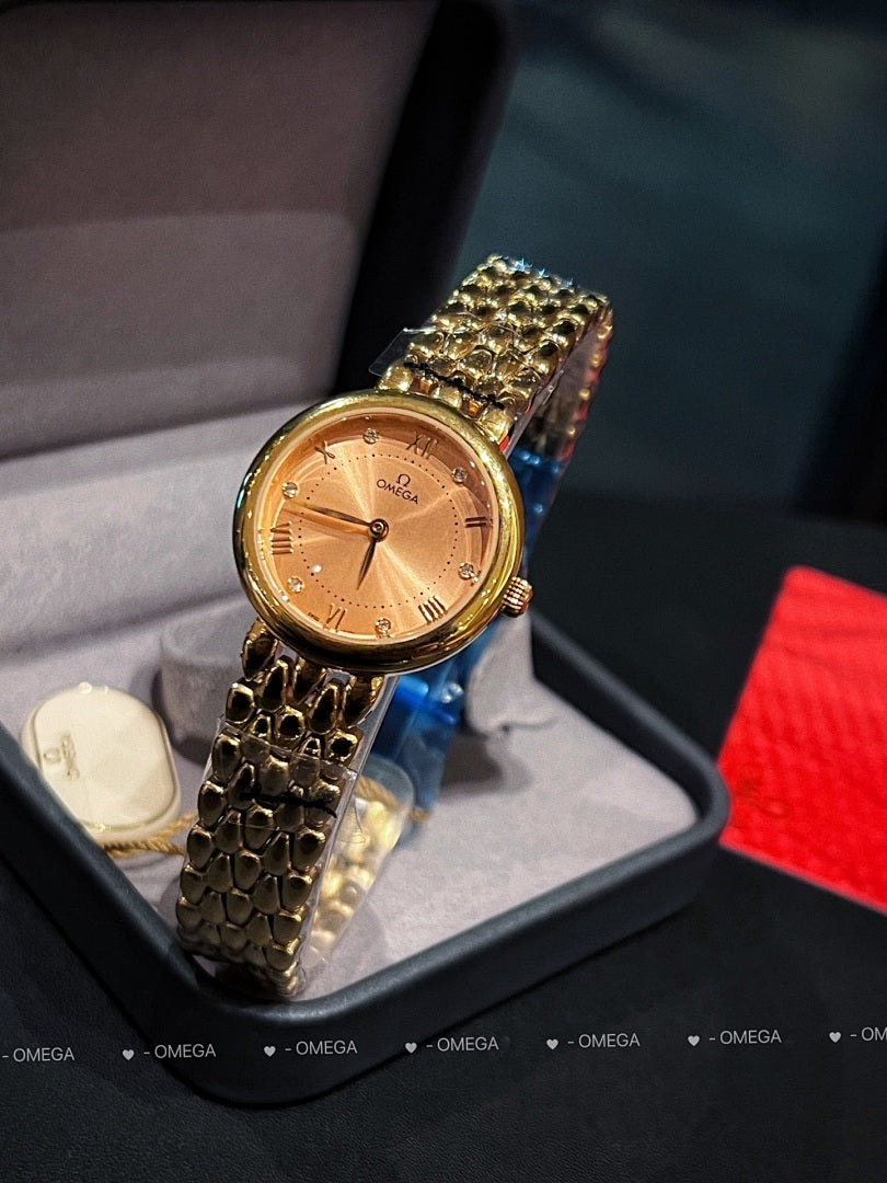 Omega wristwatch with gold-tone case, champagne dial, and textured gold link bracelet