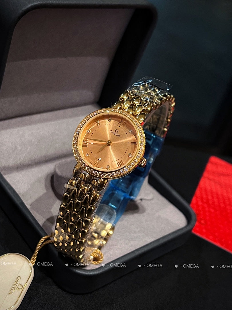 Omega wristwatch with gold-tone case, champagne dial, and textured gold bracelet