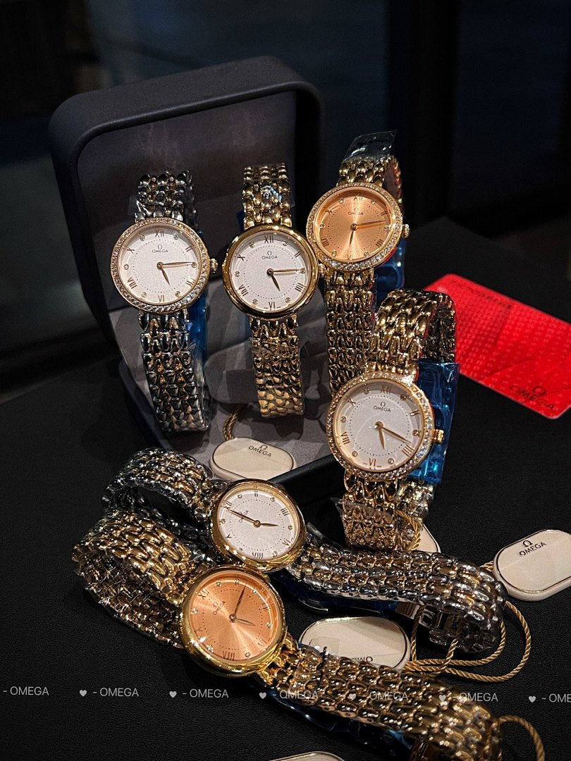 Omega watch set with multiple metal link wristwatches in gold, silver, and rose tones