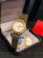 Omega wristwatch with gold-tone case, white dial, and textured gold link bracelet