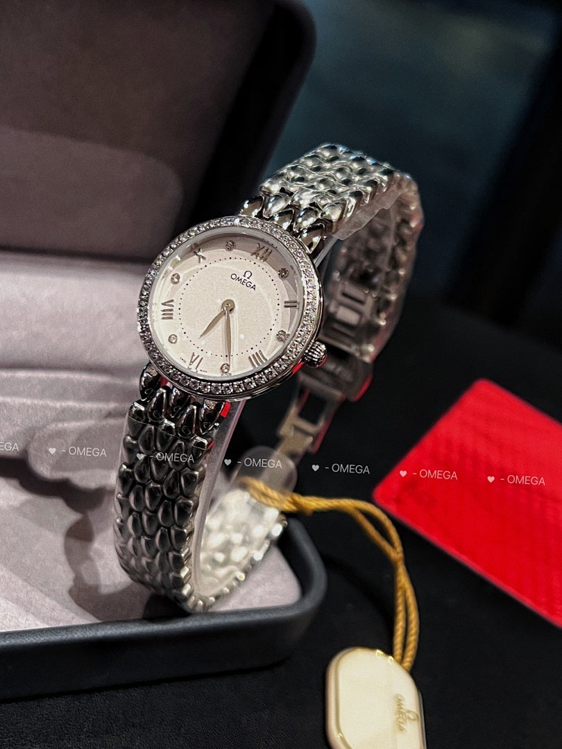 Omega watch with silver link bracelet, white dial, and yellow cord with oval tag