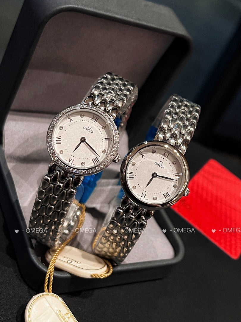 Omega watch pair with silver link bracelets and white dials, with yellow cord details