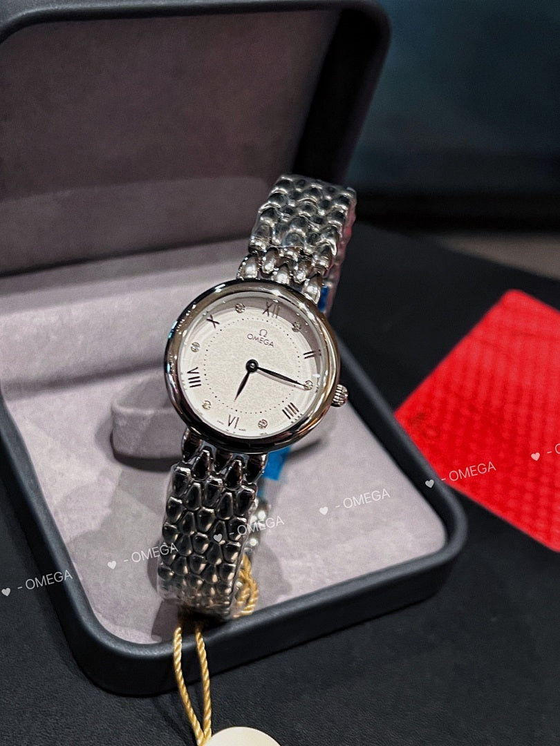 Omega watch with silver link bracelet, white dial, and small round tag on a cord