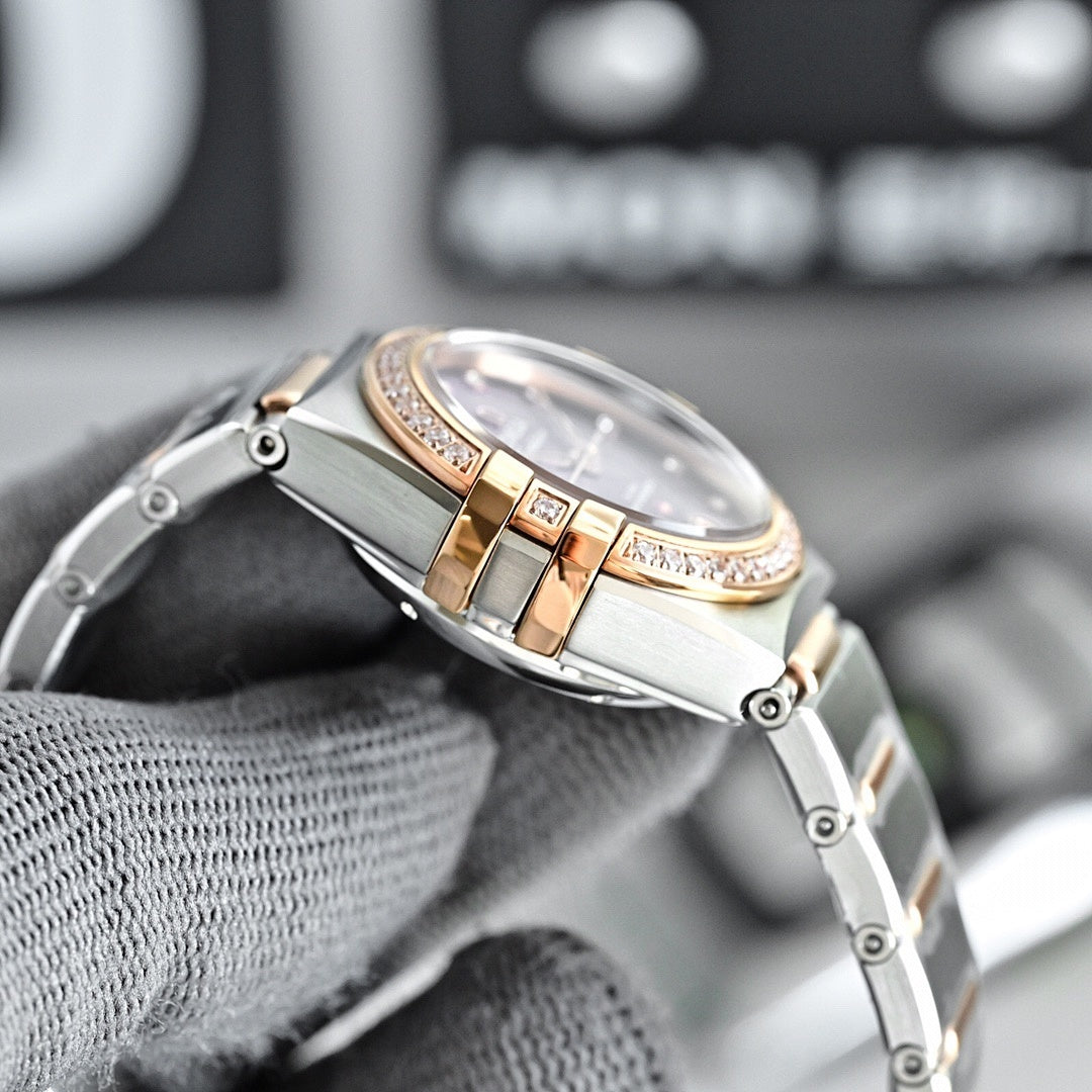 Omega wristwatch case and crystal from an angle, with rose-gold bezel and diamond trim.