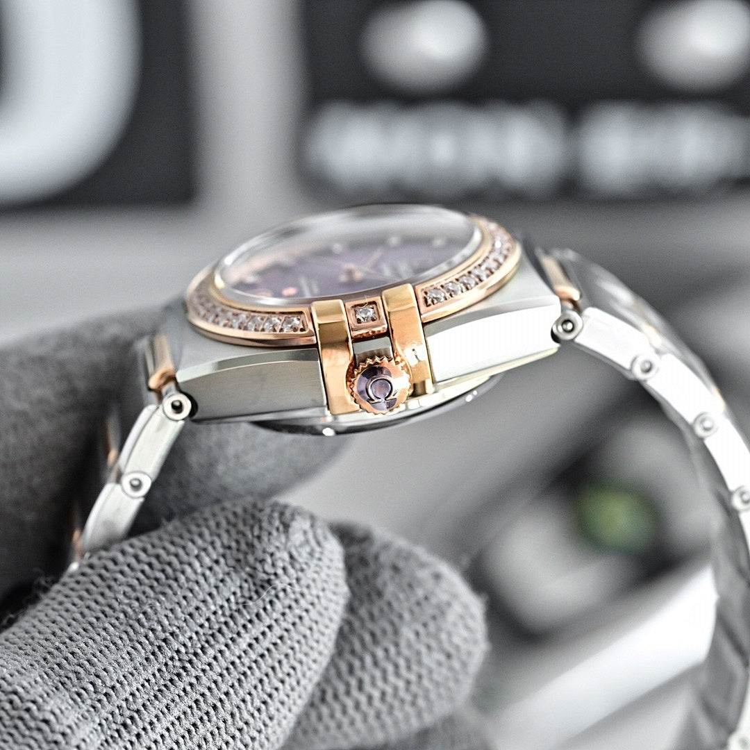 Omega wristwatch back view with rose-gold center details and metal bracelet links.
