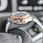 Two-tone wristwatch with light-blue dial, metal bracelet, and rose-gold bezel
