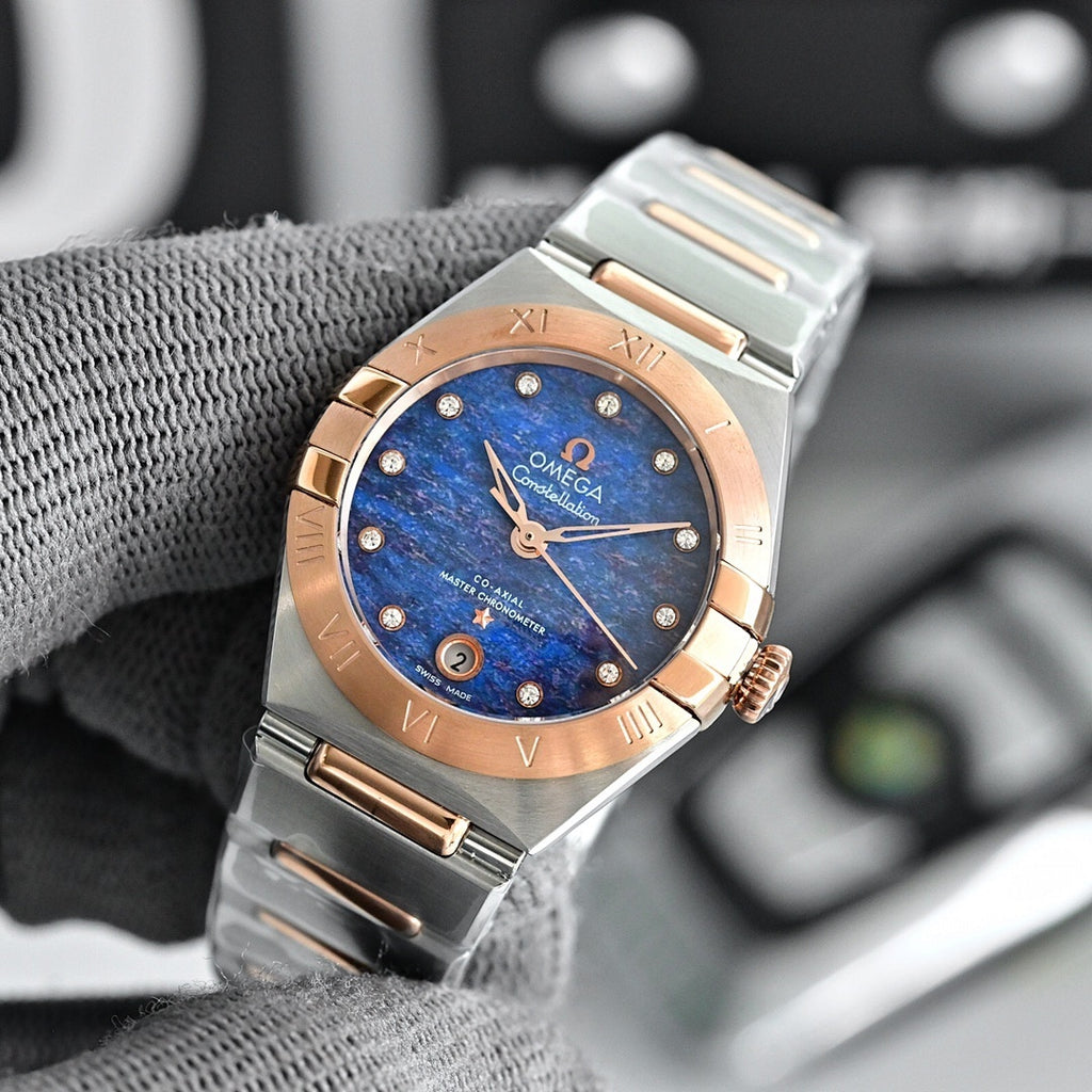 Two-tone wristwatch with blue dial, metal bracelet, and rose-gold bezel