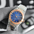Two-tone wristwatch with blue dial, metal bracelet, and rose-gold bezel