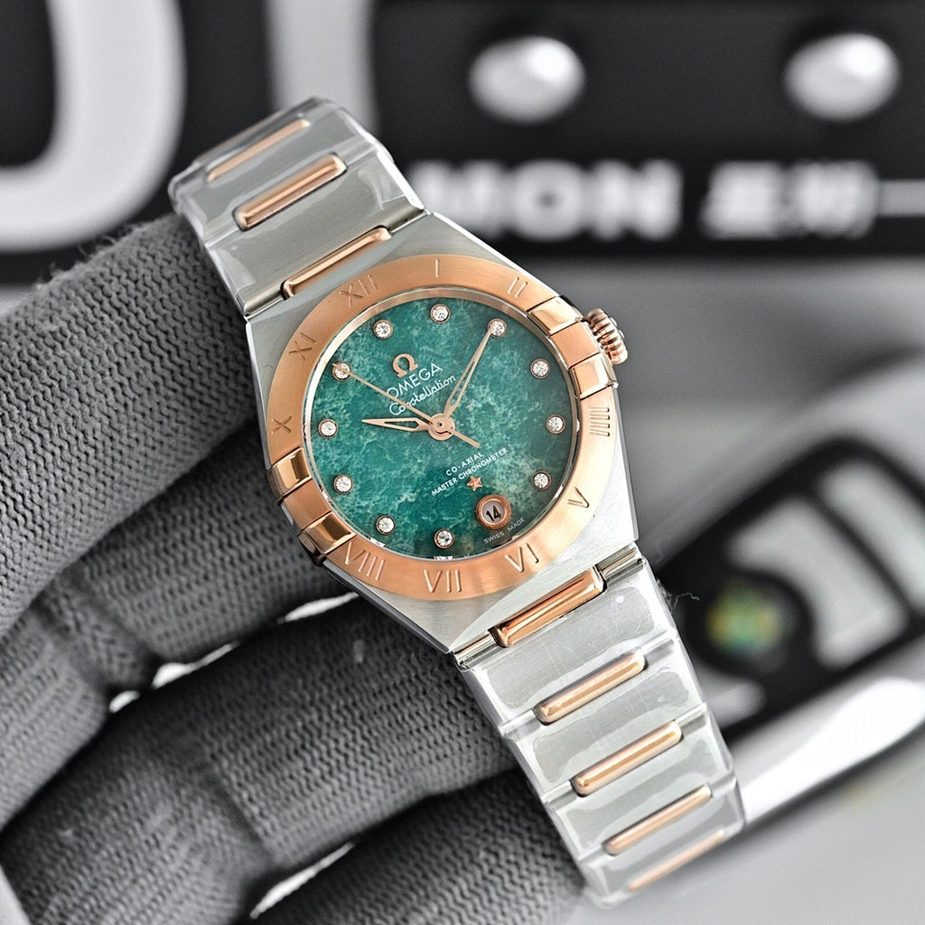 Two-tone wristwatch with green dial, metal bracelet, and rose-gold bezel