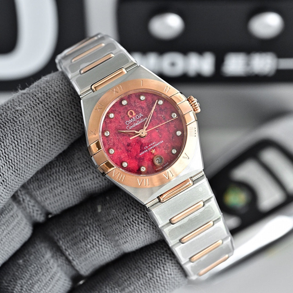 Two-tone wristwatch with red dial, metal bracelet, and rose-gold bezel