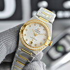 Two-tone watch with white dial, gold bezel with stones, and steel bracelet