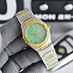 Two-tone watch with green dial and gold bezel on steel bracelet
