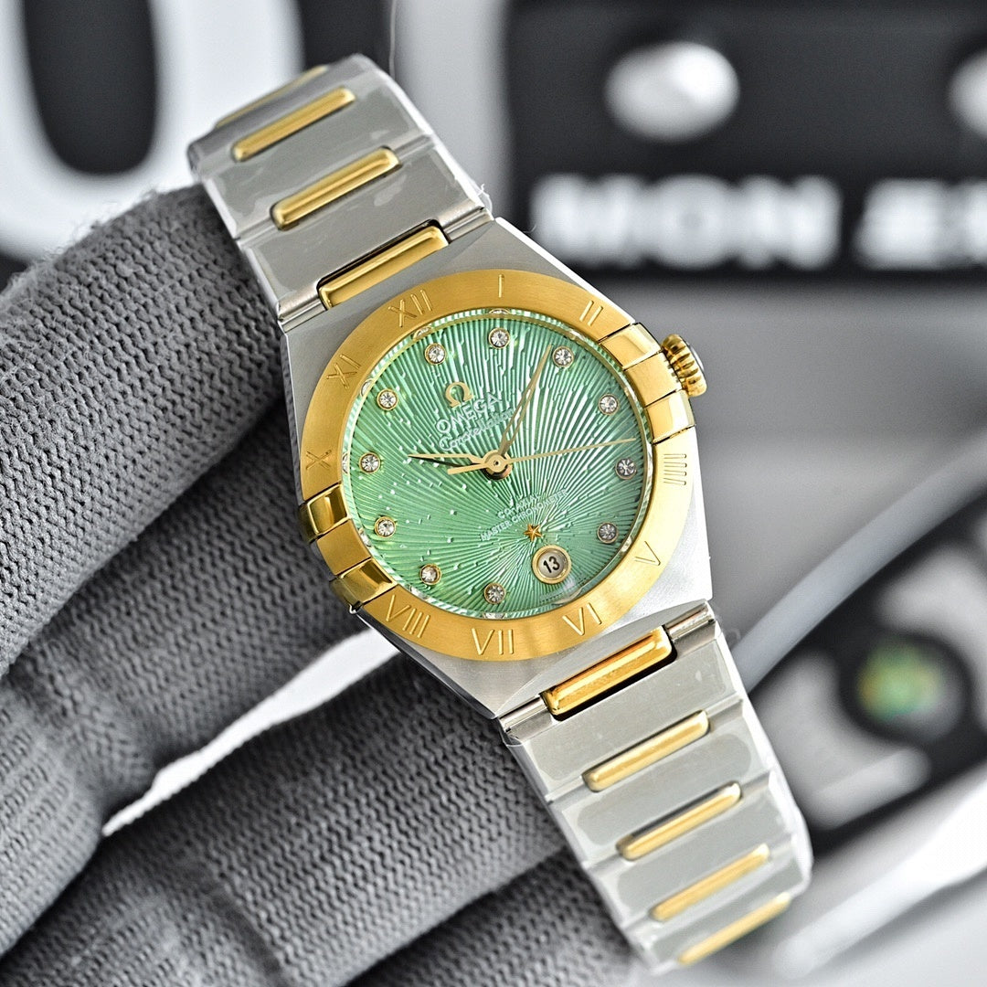 Two-tone watch with green dial, gold bezel, and steel bracelet with gold accents