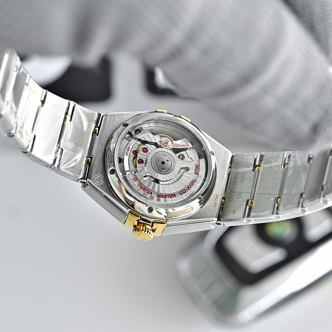 Two-tone watch case back with mechanical dial detail and steel-and-gold bracelet