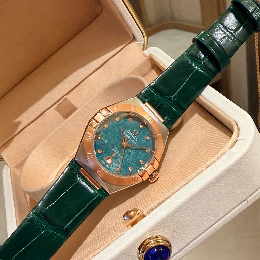 Omega wristwatch with green dial, rose-gold case, green leather strap