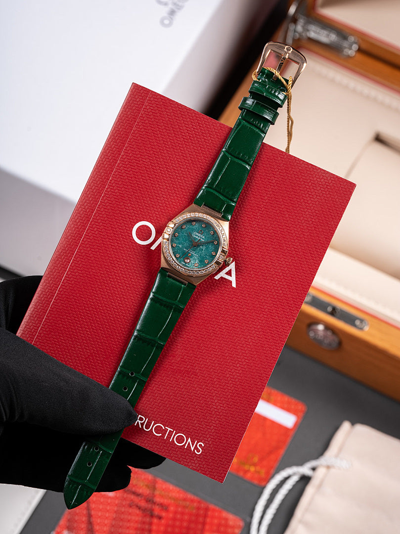 Omega wristwatch with green dial, green leather strap and clasp, held by black glove