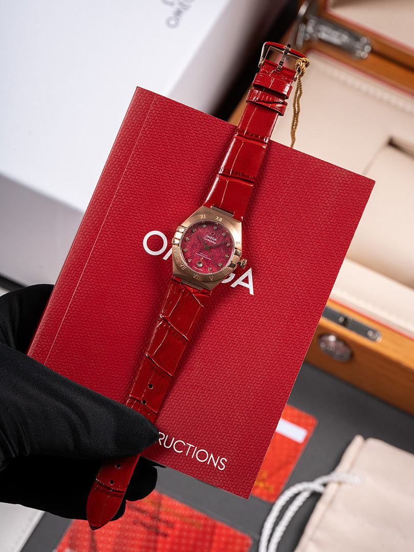Wristwatch with red leather strap and round red dial in red gift box