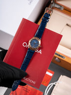 Wristwatch with blue leather strap and round blue dial in red gift box