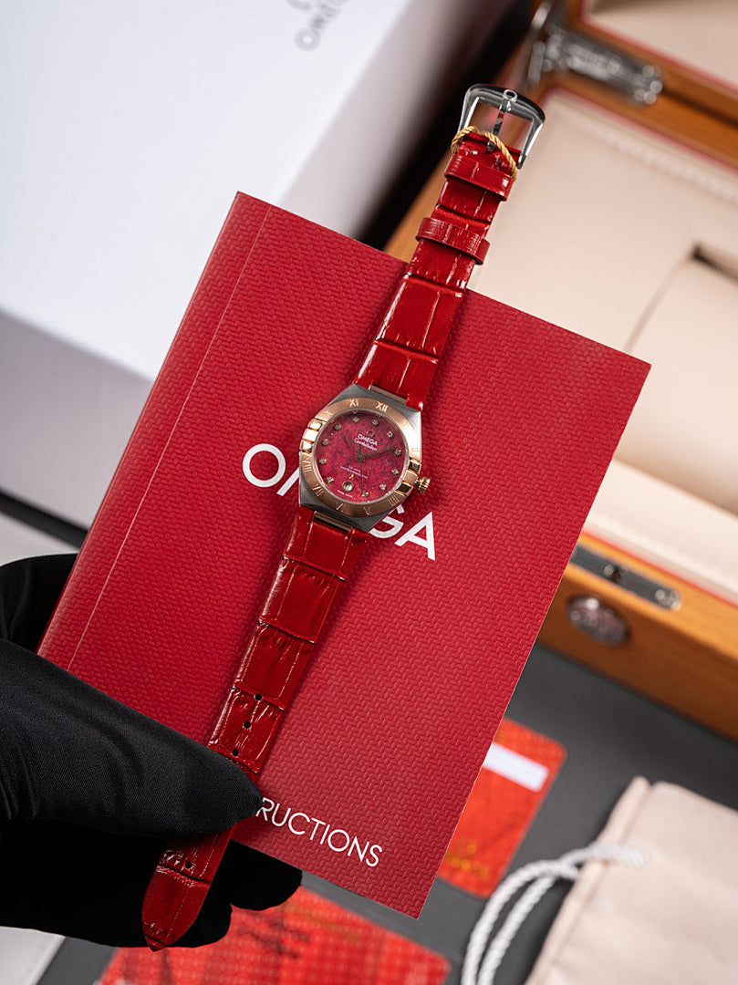Wristwatch with red leather strap and round red dial in red gift box