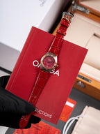 Wristwatch with red leather strap and round red dial in red gift box
