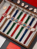 Set of wristwatches in a wooden tray with red, blue, green and brown leather straps