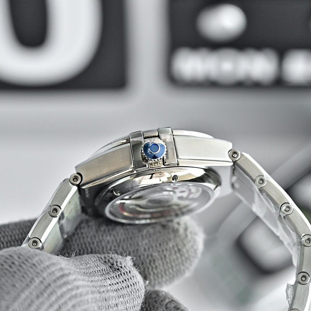 Omega Constellation wristwatch with silver case and transparent caseback, blue center detail