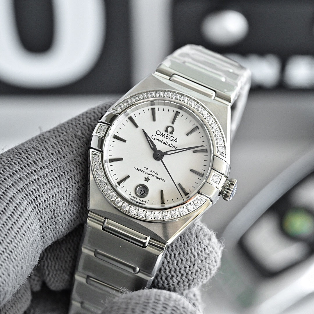 Omega Constellation wristwatch with silver bracelet, white dial, and diamond bezel