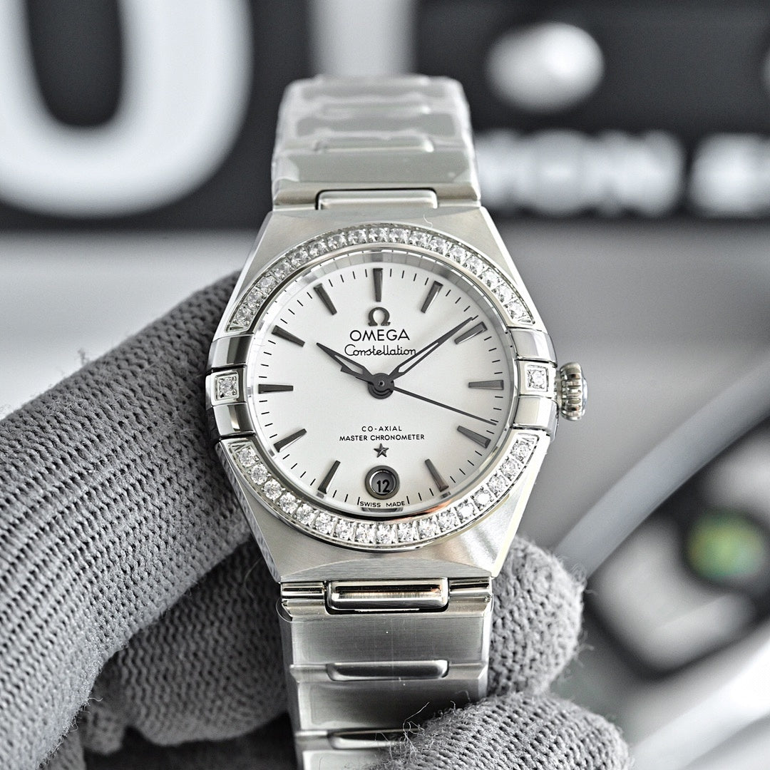 Omega Constellation wristwatch with silver bracelet, white dial, and diamond bezel