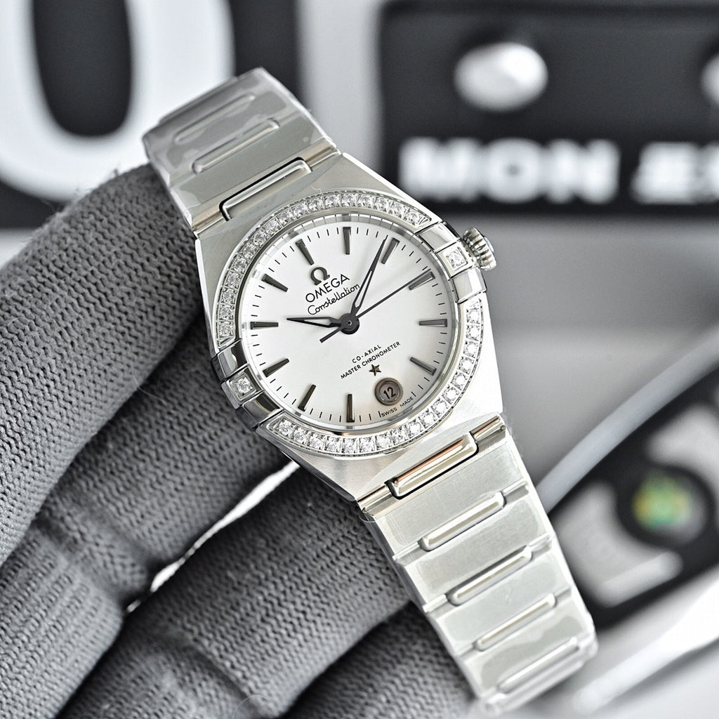 Omega Constellation wristwatch with silver bracelet, white dial, and diamond bezel