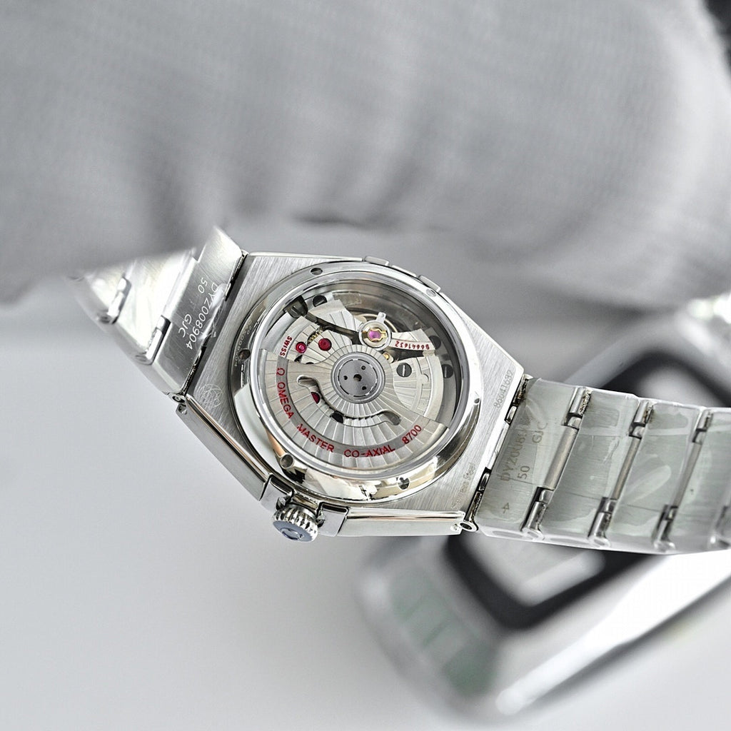 Omega Constellation wristwatch with transparent caseback showing mechanical movement