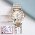 Omega watch with silver-and-gold metal bracelet, jeweled bezel, white dial, three hands