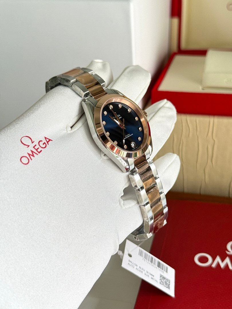 Two-tone metal wristwatch with dark blue dial on white gloves, angled view