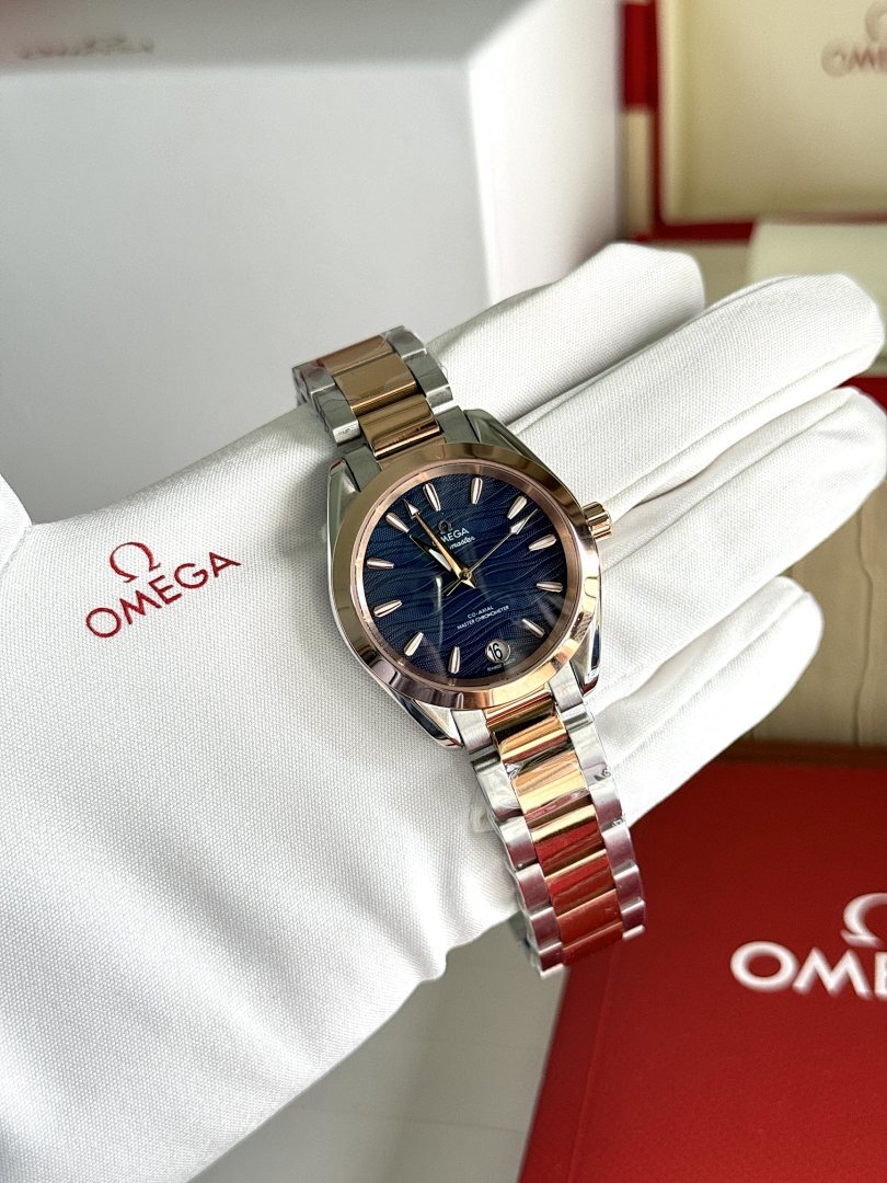 Two-tone metal wristwatch with dark blue dial on white gloves, full face view