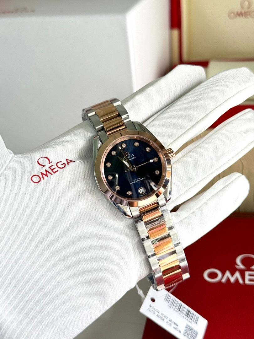 Omega wristwatch with two-tone metal bracelet and dark blue dial on white glove
