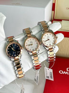Omega wristwatches set of three with two-tone metal bracelets on white gloves