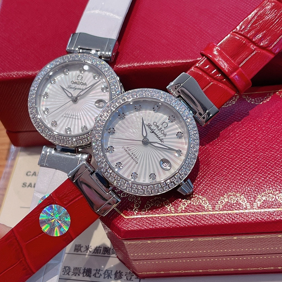 Omega watch pair with rhinestone bezels, white dials, red and gray straps