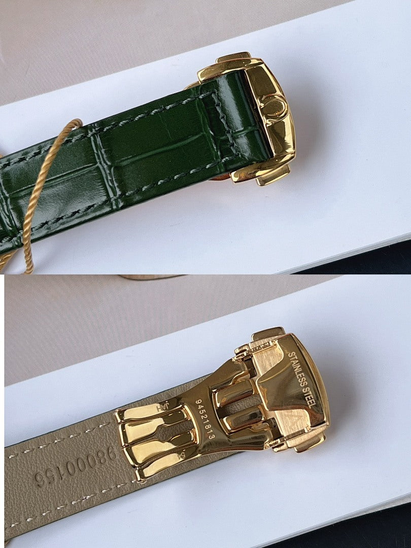 Green leather watch strap with gold-tone buckle and stitched texture