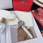 Round watch with white leather strap, diamond bezel, and subdials on a silver dial
