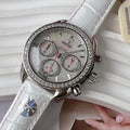 Round diamond-bezel watch with white leather strap and three subdials on a silver face