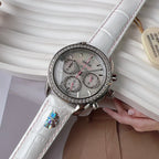 Round diamond-bezel watch with white leather strap and three subdials on silver dial