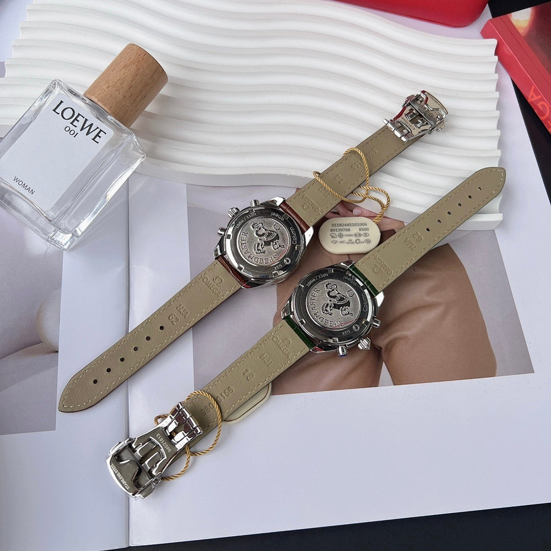 Two round watches with leather straps and jeweled bezels on a decorative display