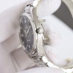Omega wristwatch profile view with crown and stainless steel bracelet links
