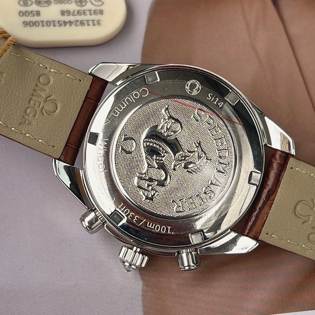Watch caseback on brown leather strap, engraved metal back with animal crest