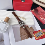 Chronograph watch with brown leather strap and silver bezel, black dial with three subdials