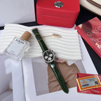 Omega watch with green leather strap, black chronograph dial, silver case on display