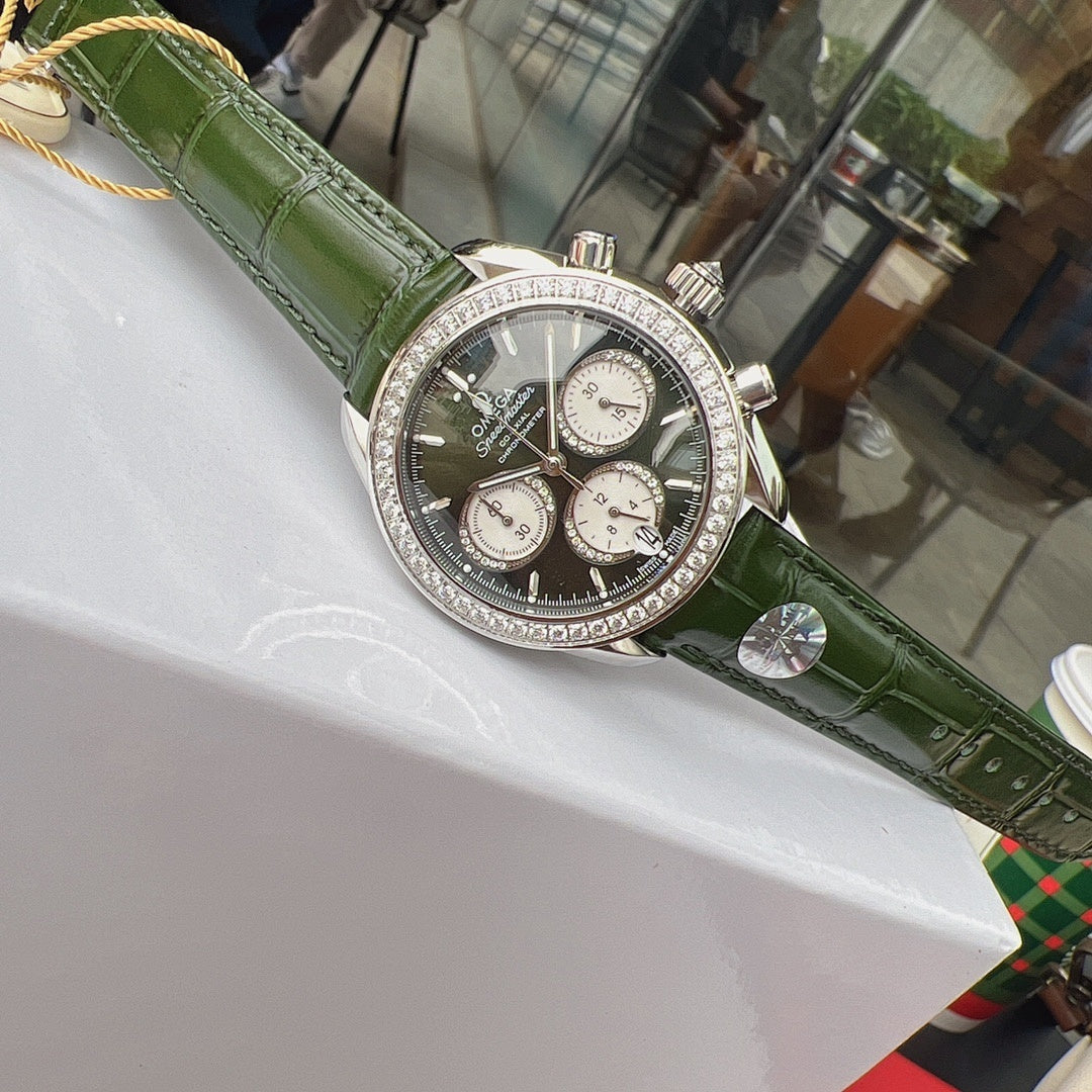 Omega watch with green leather strap, diamond bezel, black chronograph face on display