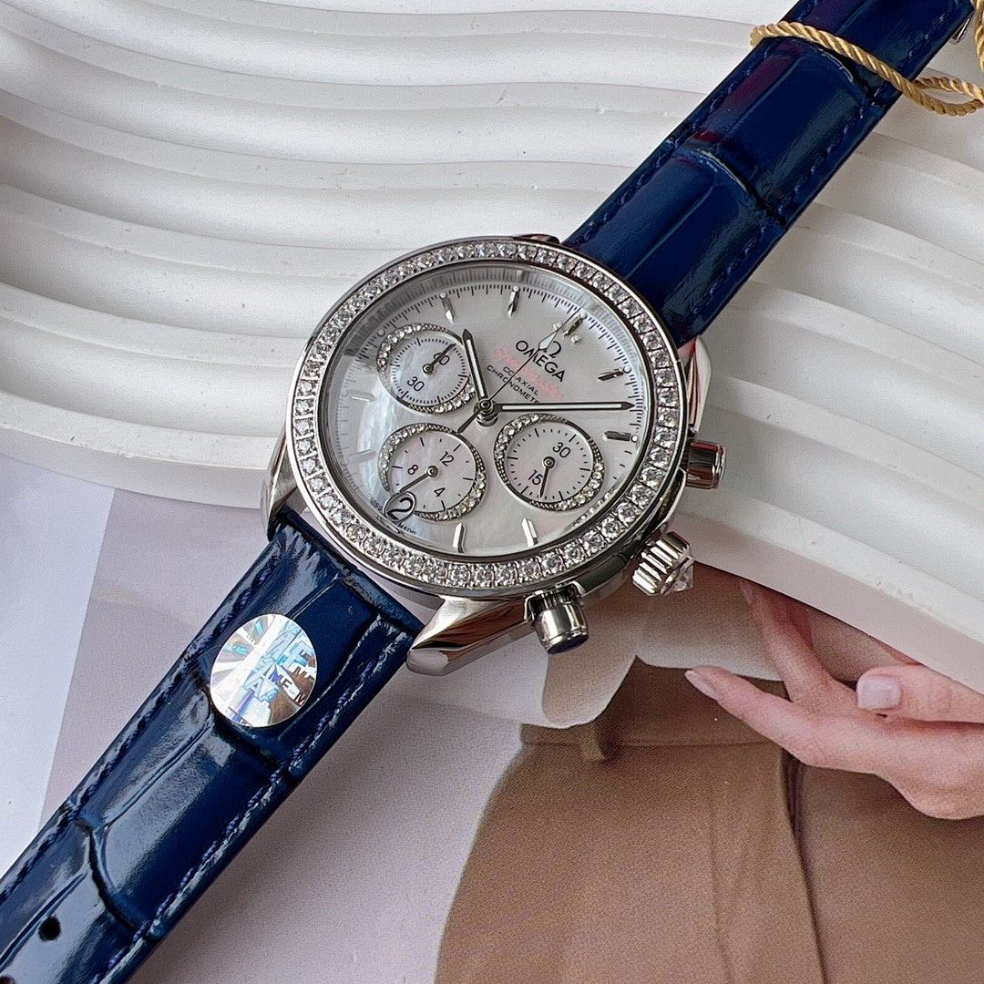Omega wristwatch close-up: blue leather strap, silver dial, diamond bezel