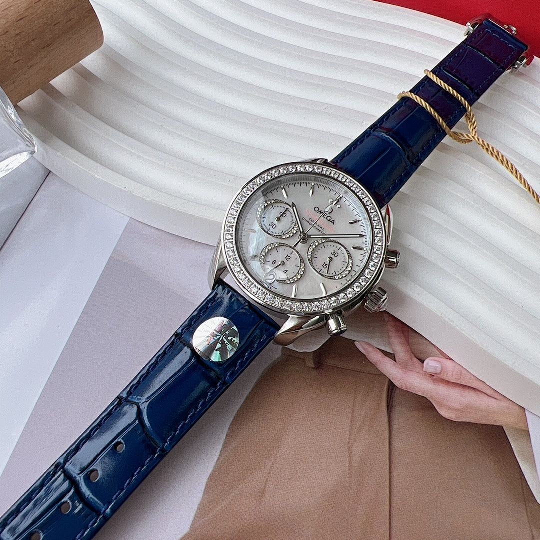 Omega wristwatch close-up with blue leather strap and silver dial, chronograph subdials