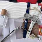Omega wristwatch with blue leather strap and silver chronograph dial, diamond rim