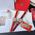 Pair of red leather strap wristwatches with rose-gold cases and white chronograph dials